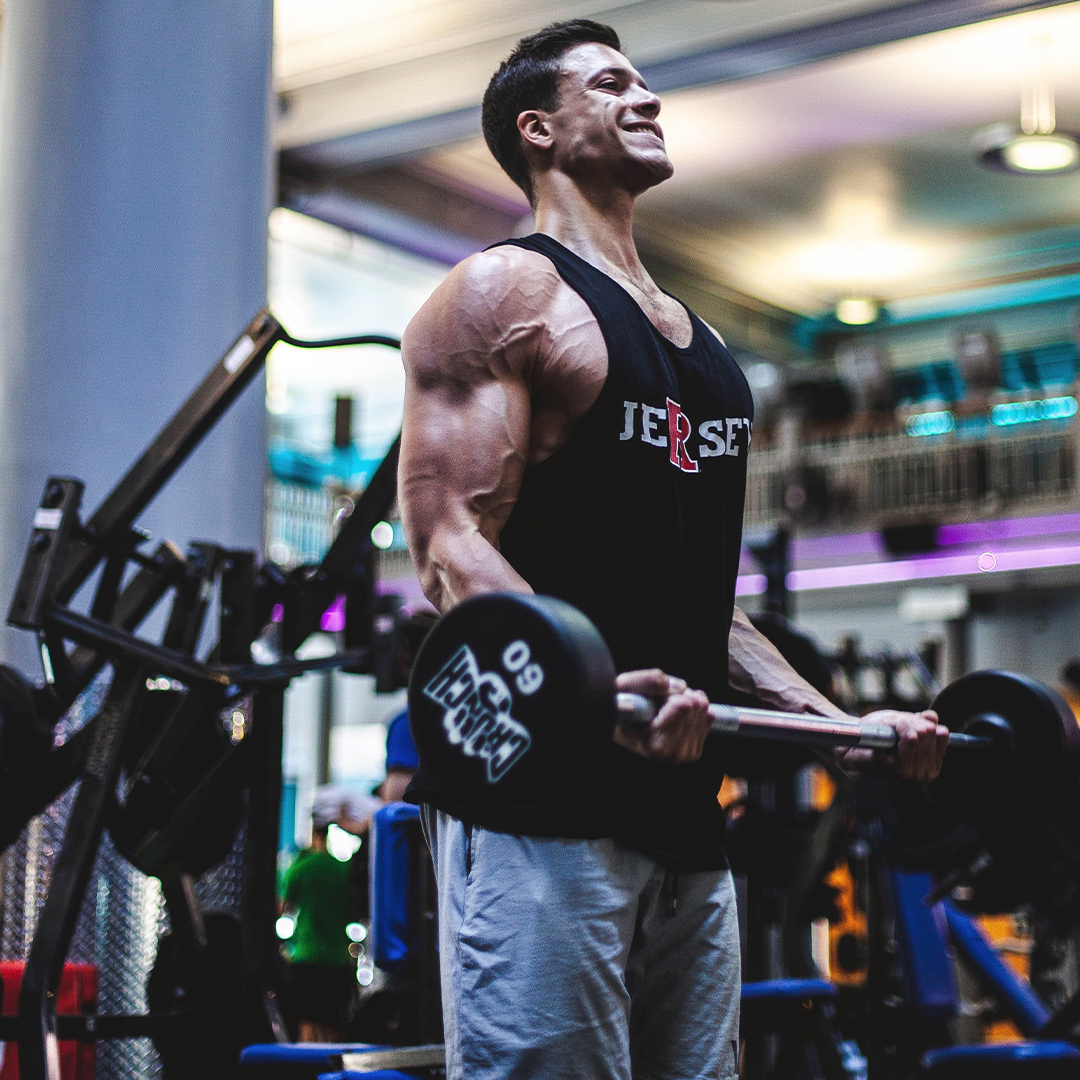 man doing curls with a barbell