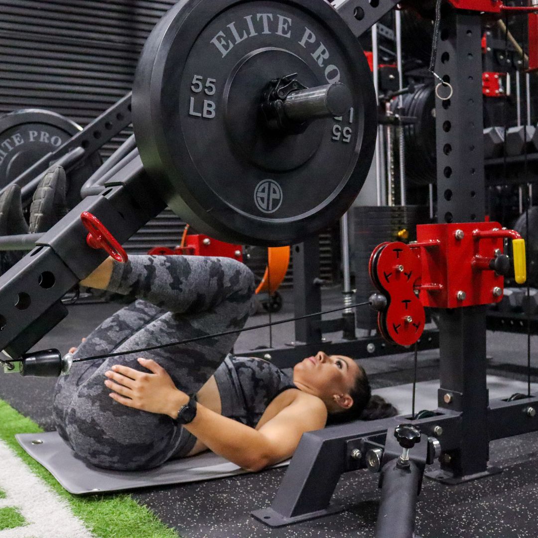 Girl using the jammer arms as a leg press