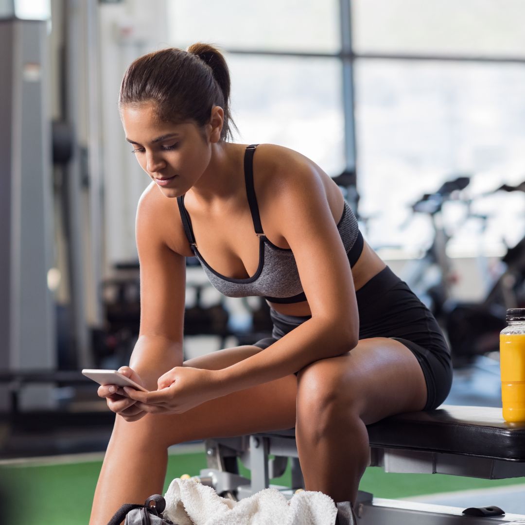 Lady on her phone at the gym